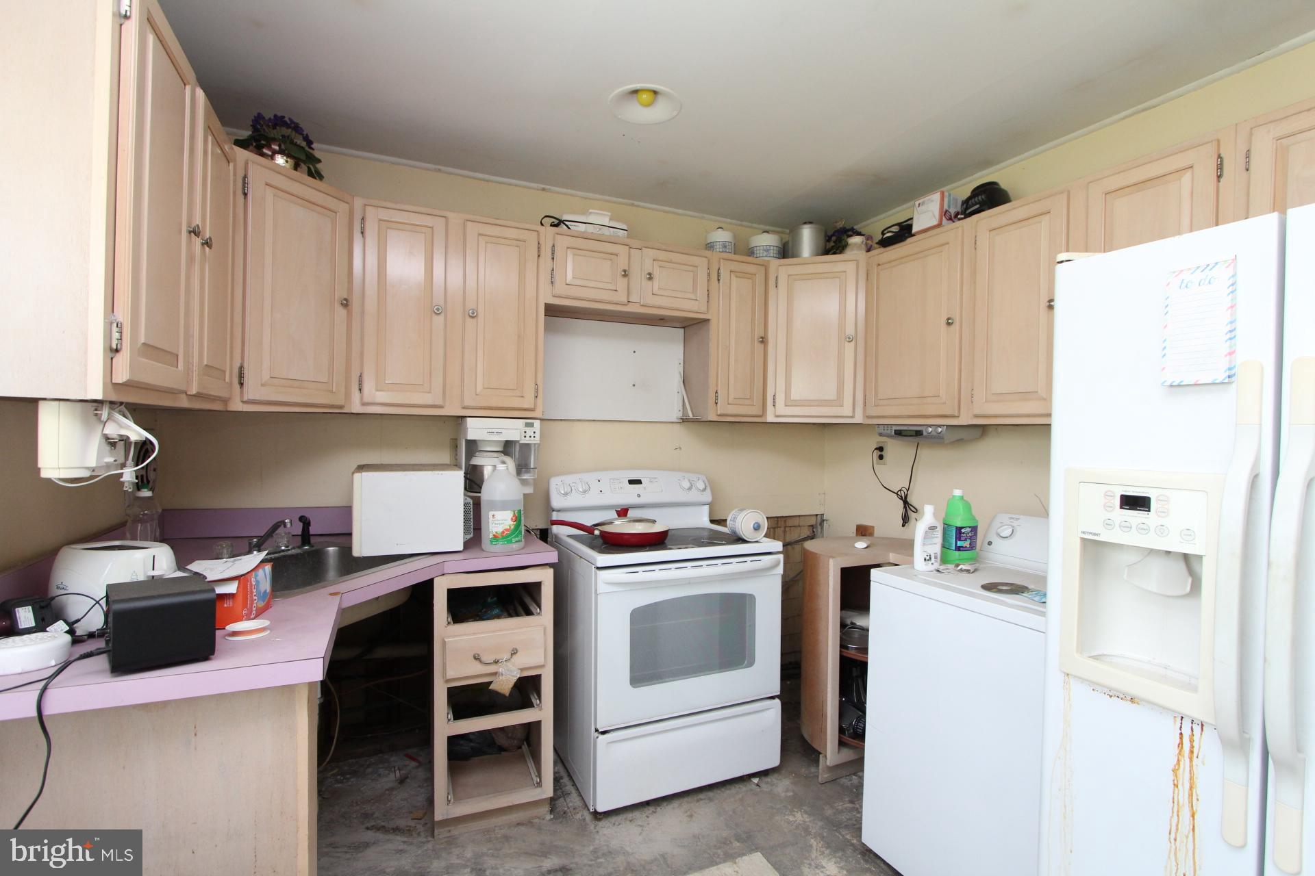 41 Jewel Lane Levittown, PA 19055 - Photo 4 of 24 a view of a kitchen with refrigerator and cabinets