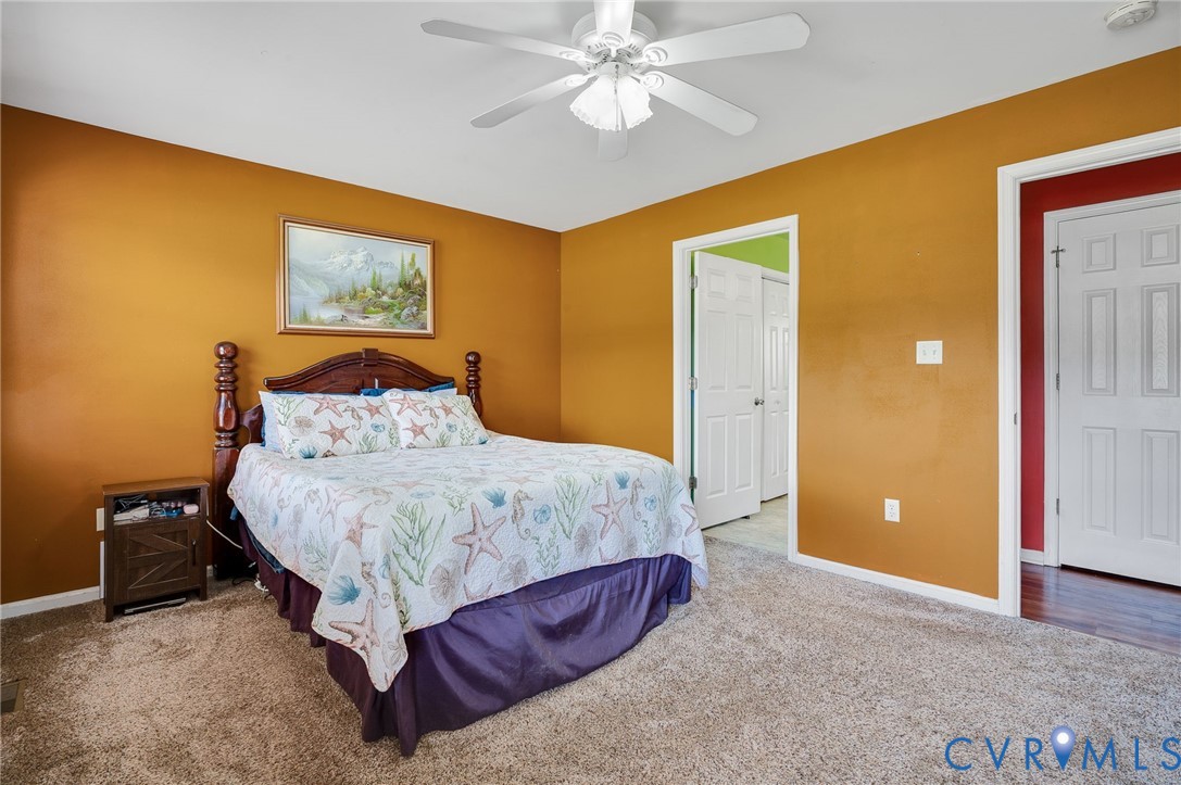 5280 West Quaker Road Disputanta, VA 23875 - Photo 27 of 33 a bedroom with a bed and a painting on the wall