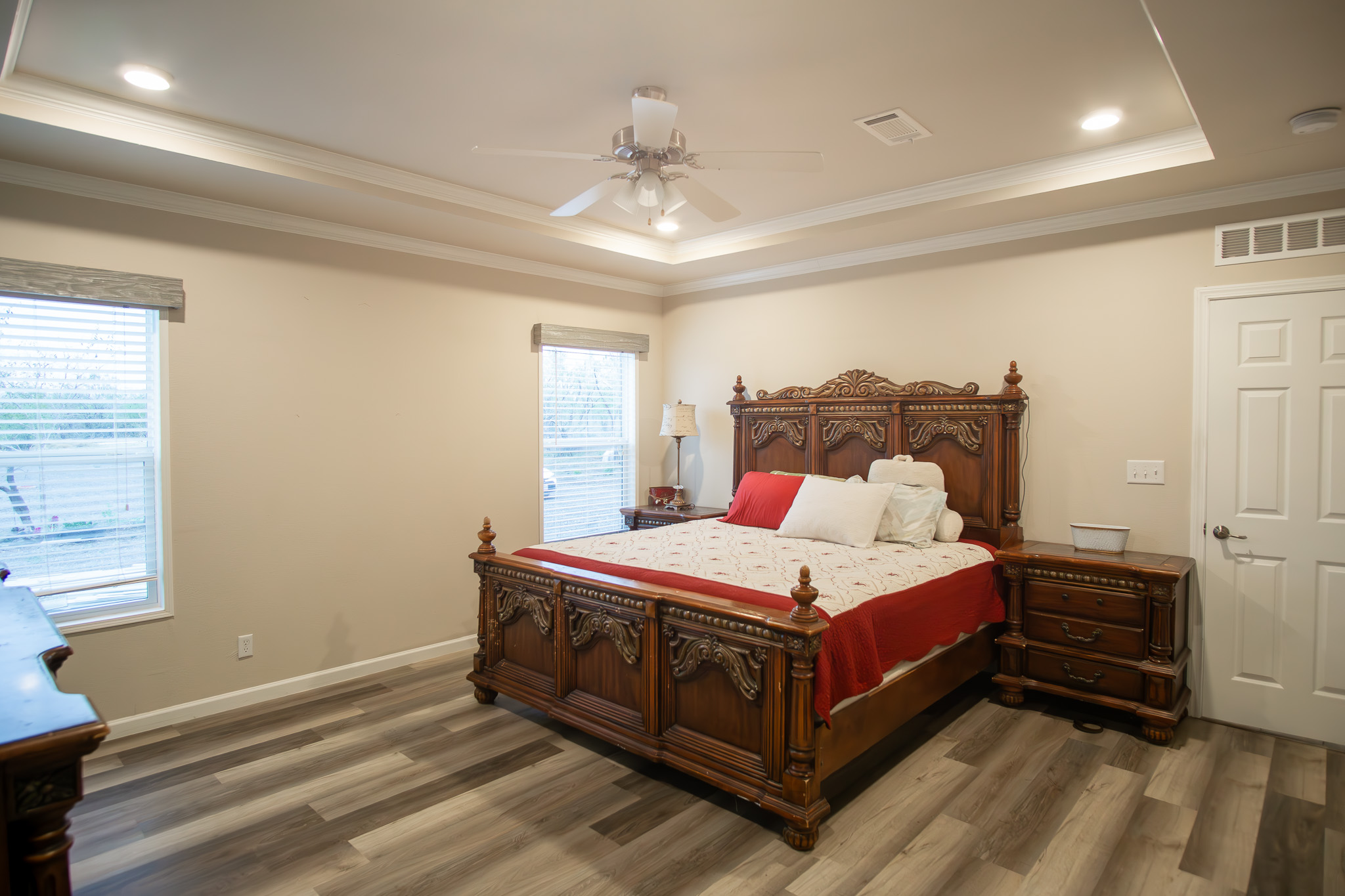 3882 Dry Creek Road Lockhart, TX 78644 - Photo 9 of 34 Bedroom featuring crown molding, dark wood-style floors, a ceiling fan, a raised ceiling, and recessed lighting