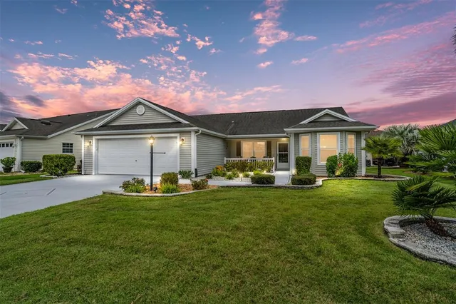a front view of a house with patio and garden
