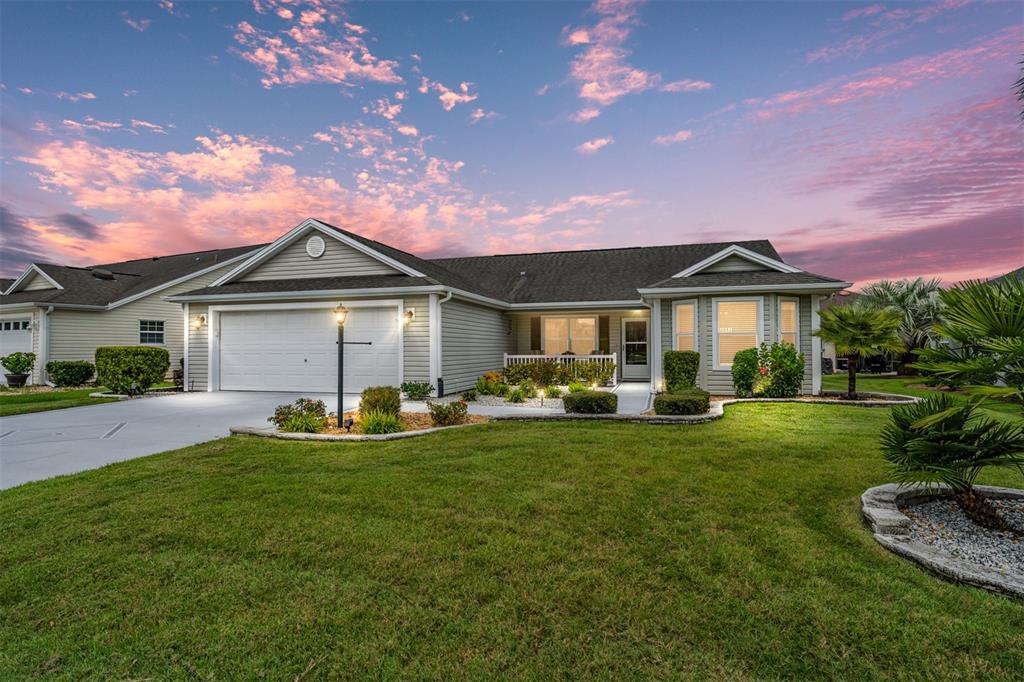a front view of a house with patio and garden