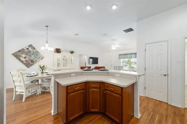 a kitchen with a sink cabinets and wooden floor