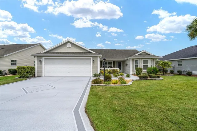 a front view of a house with yard and porch
