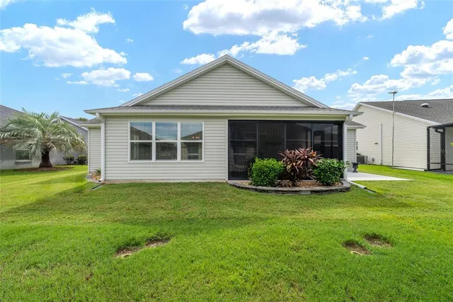 a view of a house with a backyard