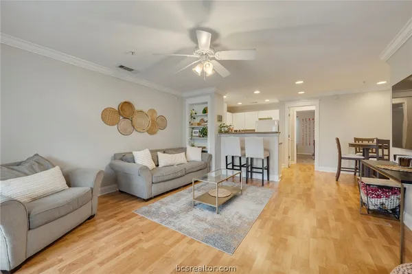 a living room with furniture and kitchen view