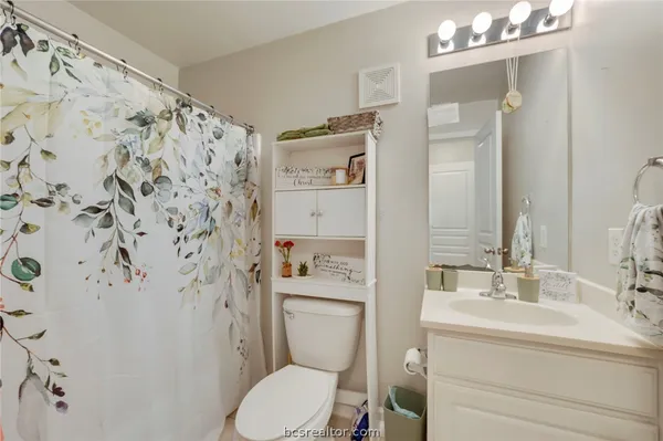 a bed room with a bed and a chair