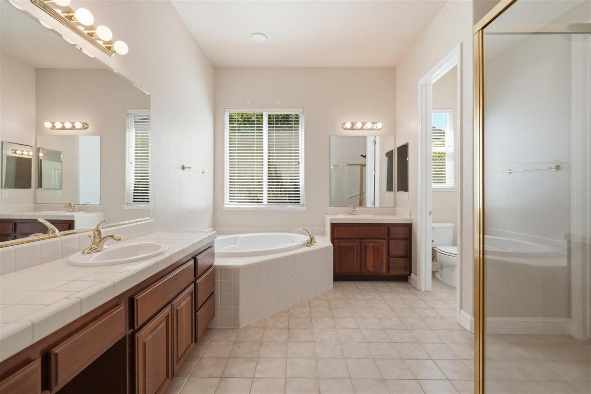 4129 Poppleton Way Carmichael, CA 95608 - Photo 31 of 48 a bathroom with a tub sink and mirror