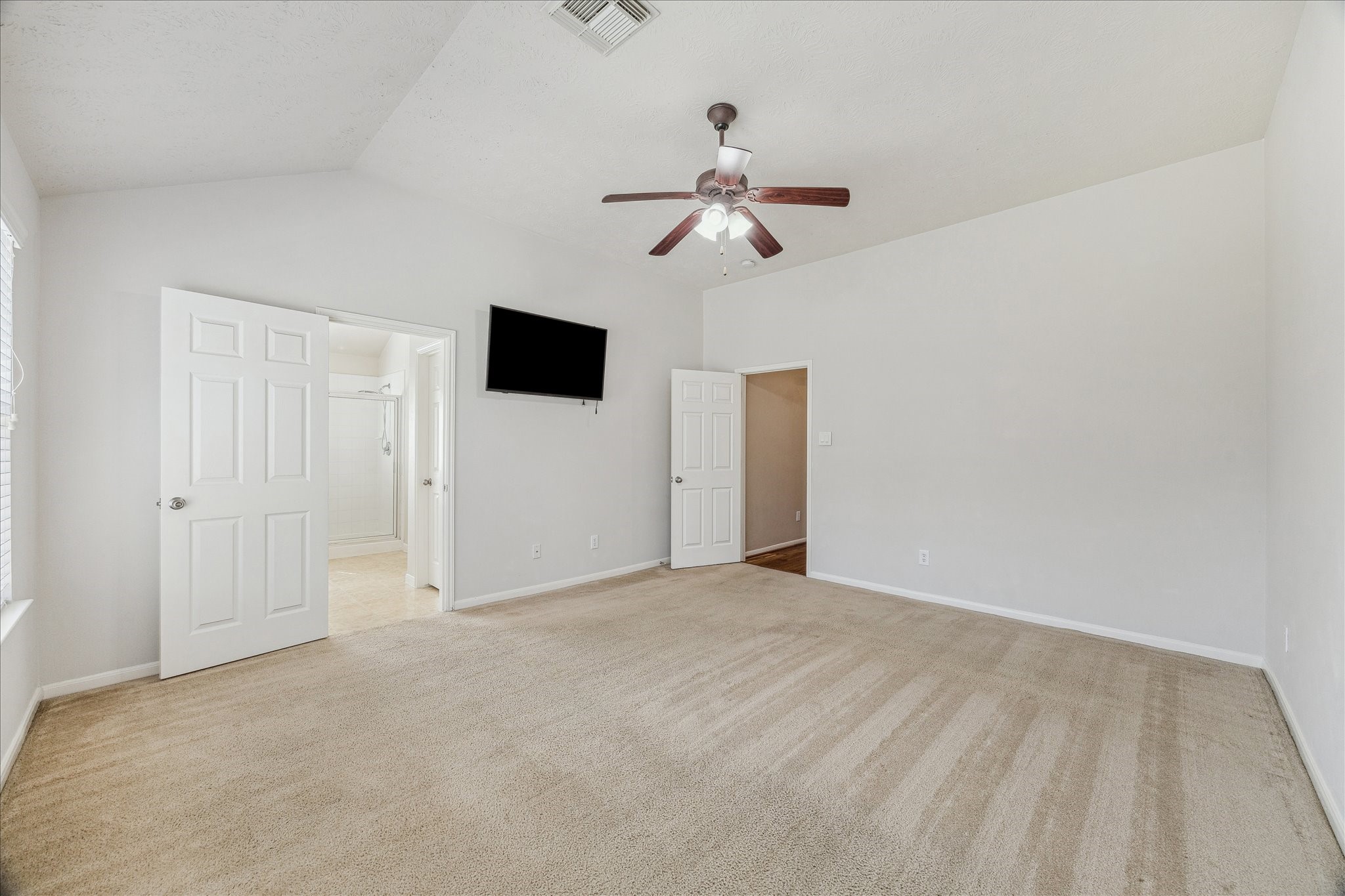 15203 Knotty Chestnut Street Cypress, TX 77429 - Photo 15 of 32 This view from the rear of the primary bedroom shows access from the entry and access to the en-suite primary bathroom.