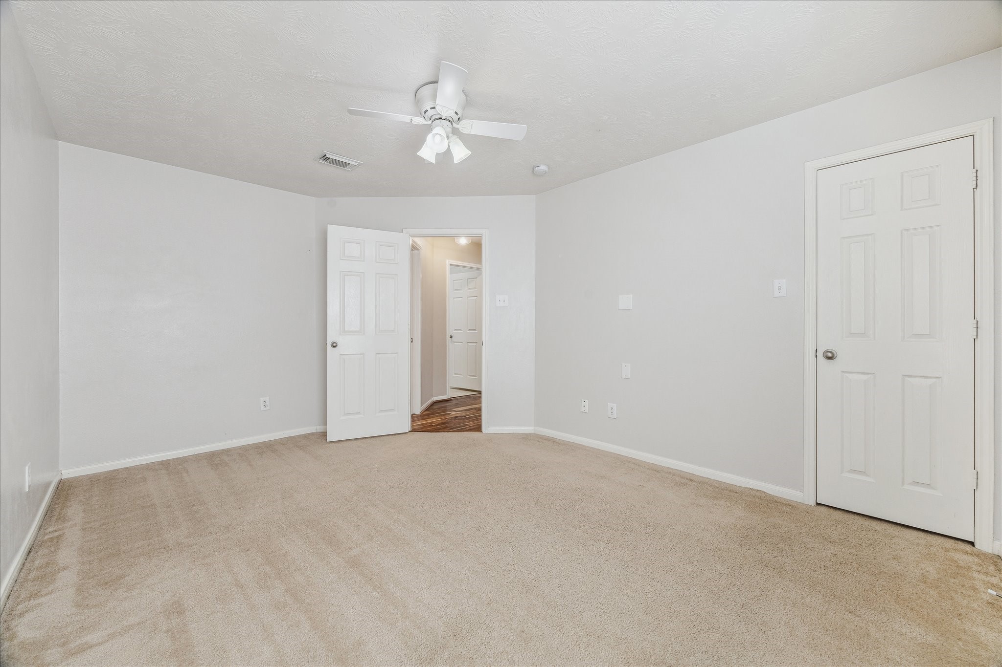 15203 Knotty Chestnut Street Cypress, TX 77429 - Photo 24 of 32 A view across bedroom 3 toward the entry. Access to the walk-in closet is at the right.