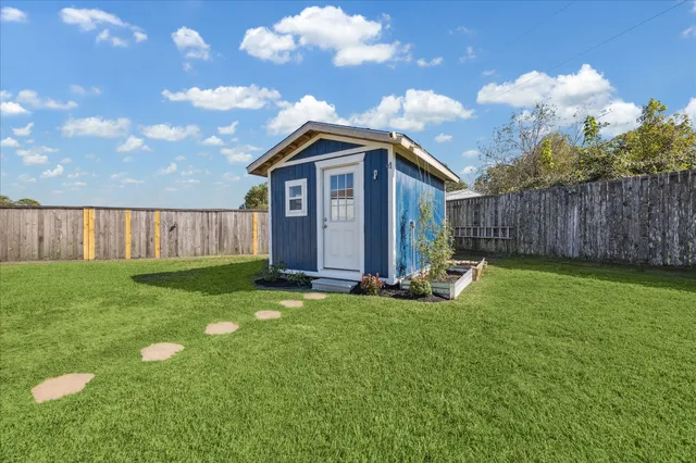 a view of an house with backyard space and garden