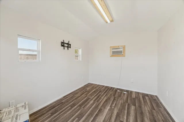 a view of small space with wooden floor and a window