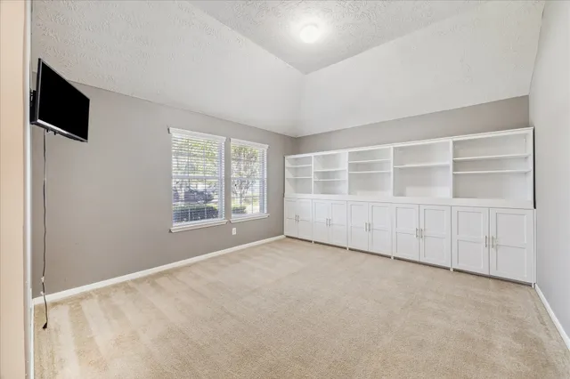 an empty room with a empty space and windows