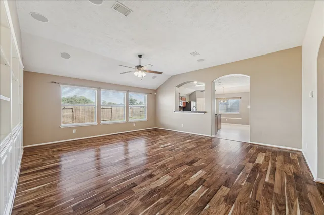 wooden floor in an empty room with a window