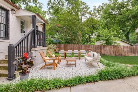 a backyard of a house with table and chairs