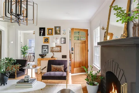 a living room with furniture and flowers