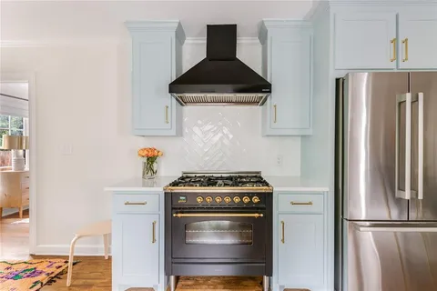 a kitchen with stainless steel appliances a stove and a refrigerator