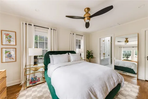 a spacious bedroom with a large bed and a chandelier