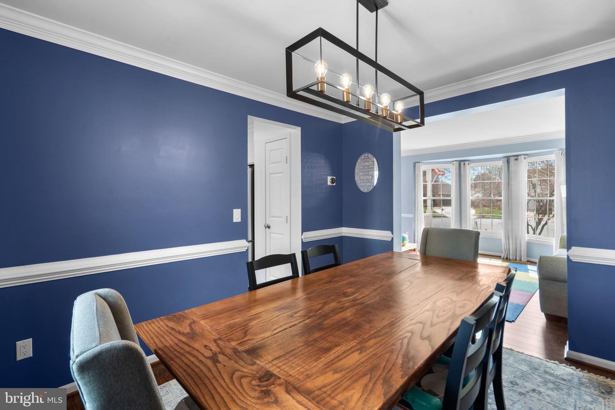 20747 Laplume Place Ashburn, VA 20147 - Photo 9 of 48 Dining Room with chair and crown molding