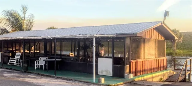 a view of balcony with two chairs and potted plants
