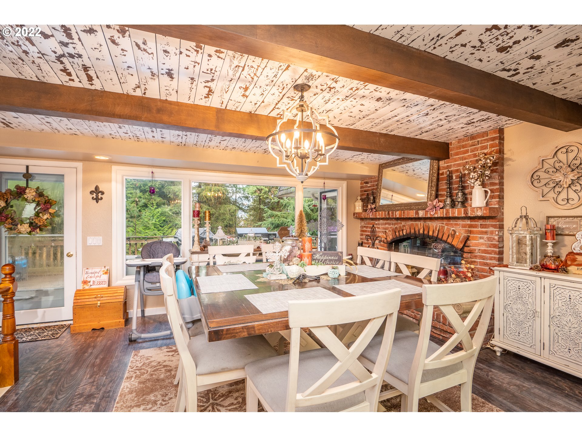 39845 Deerhorn Road Springfield, OR 97478 - Photo 8 of 29 a dining room with furniture a chandelier and wooden floor