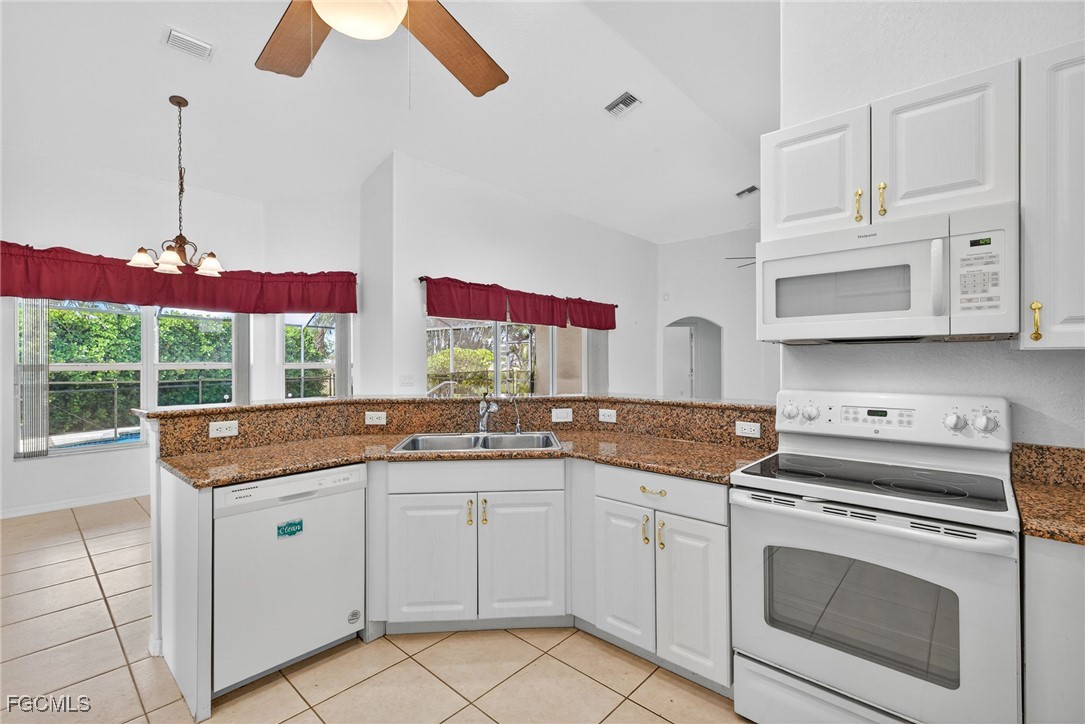 2007 Southwest 43rd Terrace Cape Coral, FL 33914 - Photo 11 of 22 a kitchen with stainless steel appliances granite countertop a stove sink and cabinets