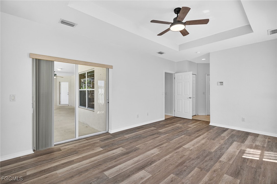 2007 Southwest 43rd Terrace Cape Coral, FL 33914 - Photo 13 of 22 a view of empty room with wooden floor and ceiling fan