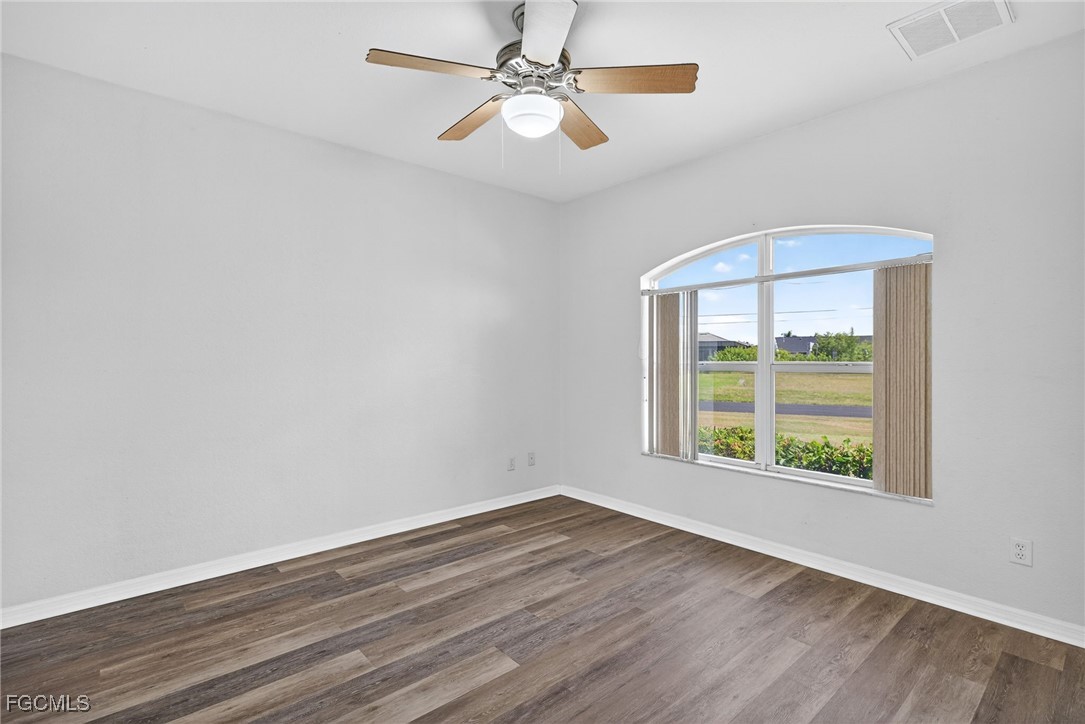 2007 Southwest 43rd Terrace Cape Coral, FL 33914 - Photo 16 of 22 wooden floor in an empty room with a window