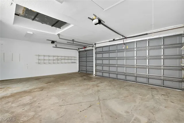 a view of a livingroom with furniture and floor to ceiling window