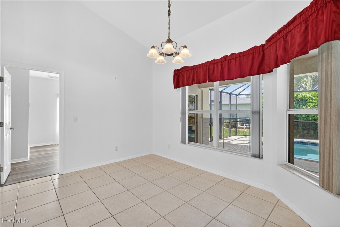 2007 Southwest 43rd Terrace Cape Coral, FL 33914 - Photo 7 of 22 a view of a room with a window and chandelier