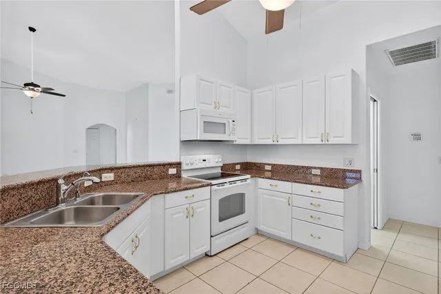 a kitchen with stainless steel appliances granite countertop a stove sink and cabinets