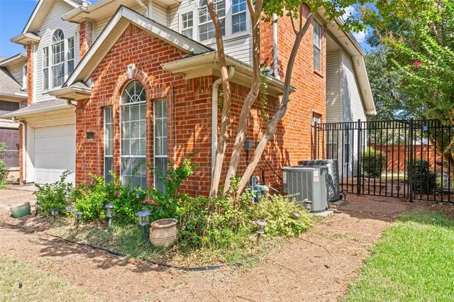 a backyard of a house with a garden and plants
