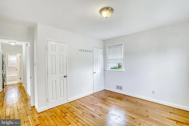 a view of room with wooden floor and fan