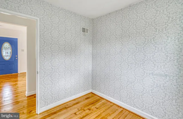 a view of a bedroom with wooden floor and bathroom