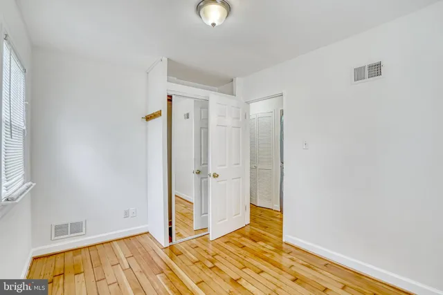 a view of a room with washing machine and racks on the wall