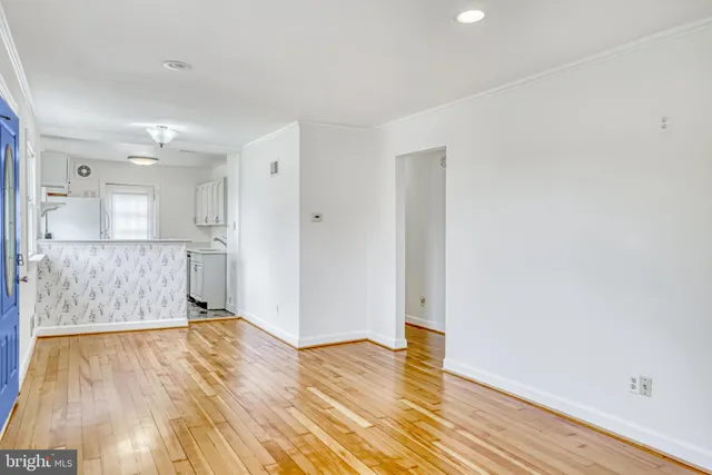 a view of empty room with wooden floor
