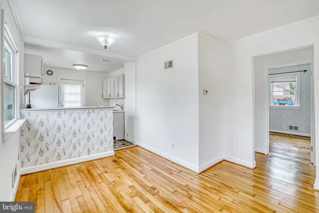 a view of a room with wooden floor and cabinet