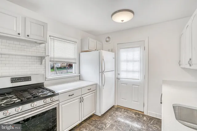 a kitchen with a stove and a refrigerator