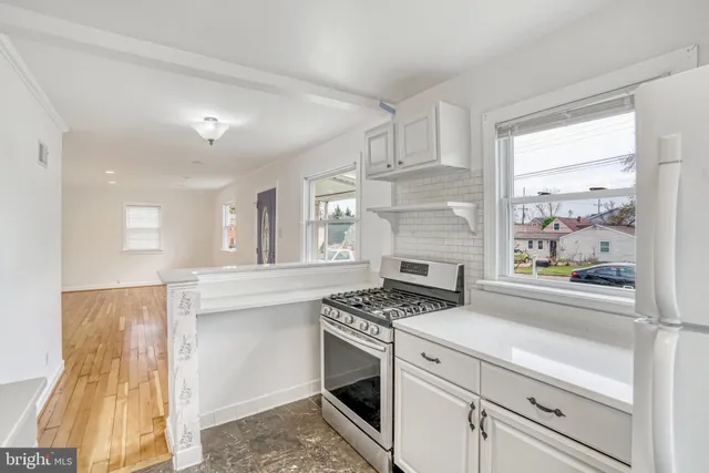 a kitchen with stainless steel appliances granite countertop a stove and a sink