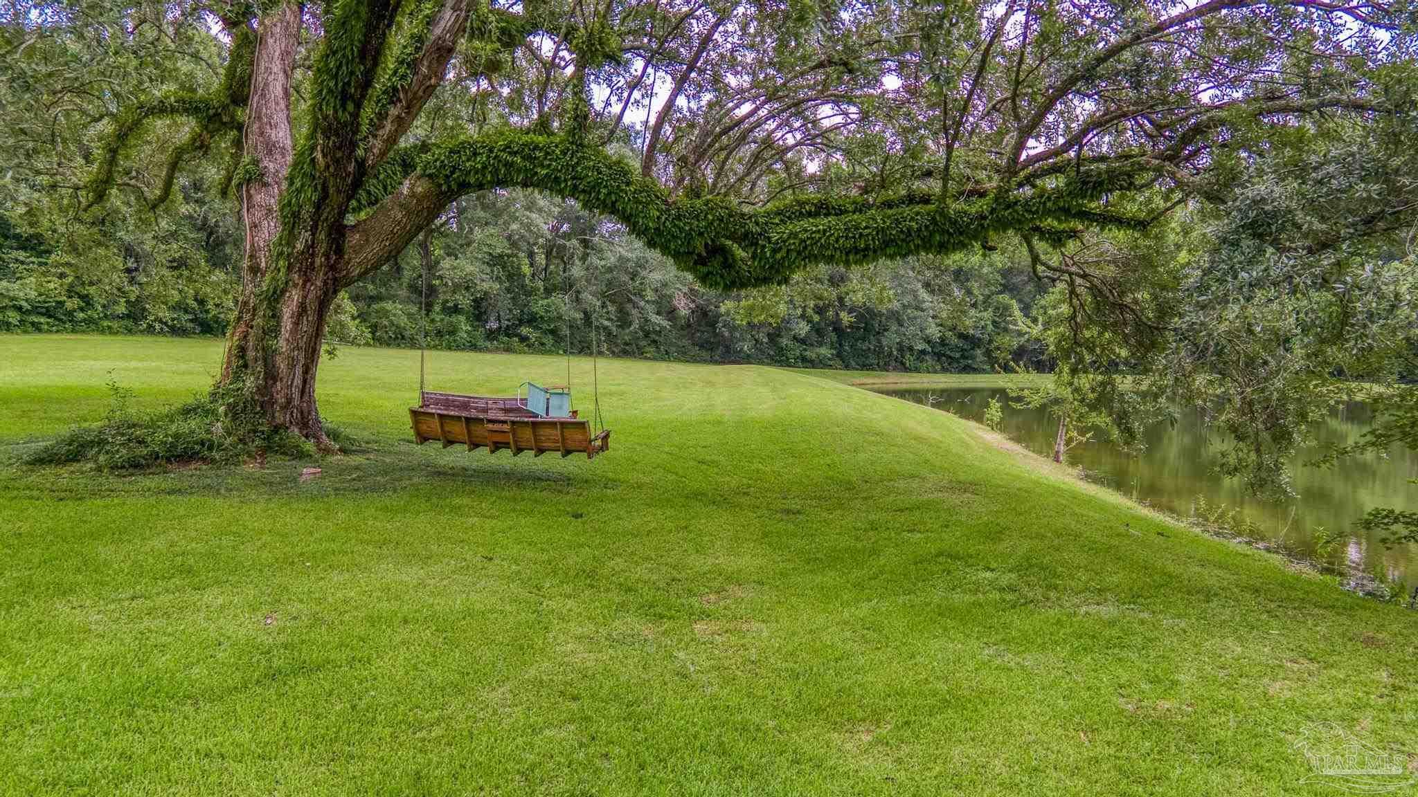 2345 Pompano Street Cantonment, FL 32533 - Photo 38 of 48 a backyard of a house with lots of green space
