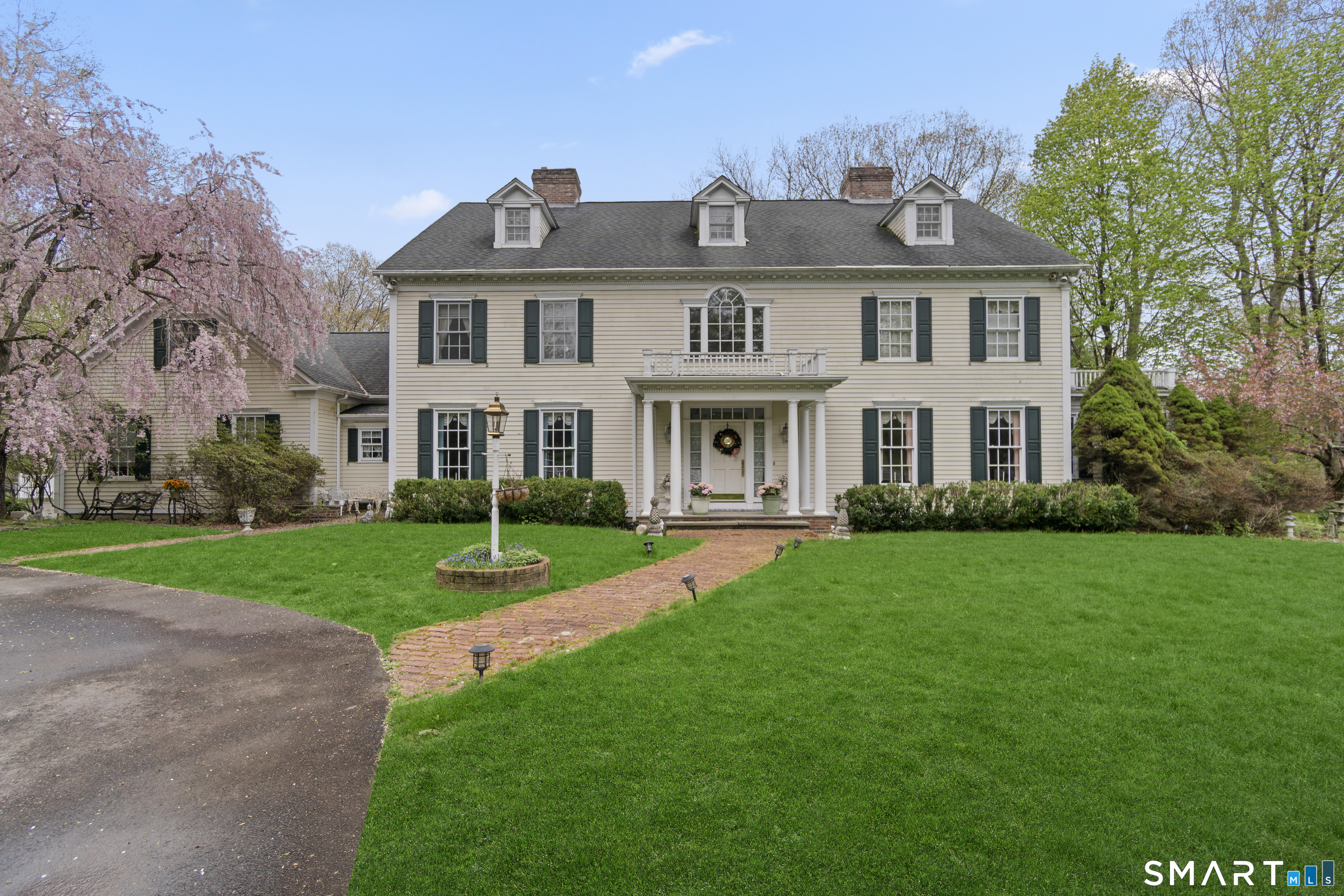 9 Perkins Road Woodbridge, CT 06525 - Photo 2 of 39 a front view of a house with a yard