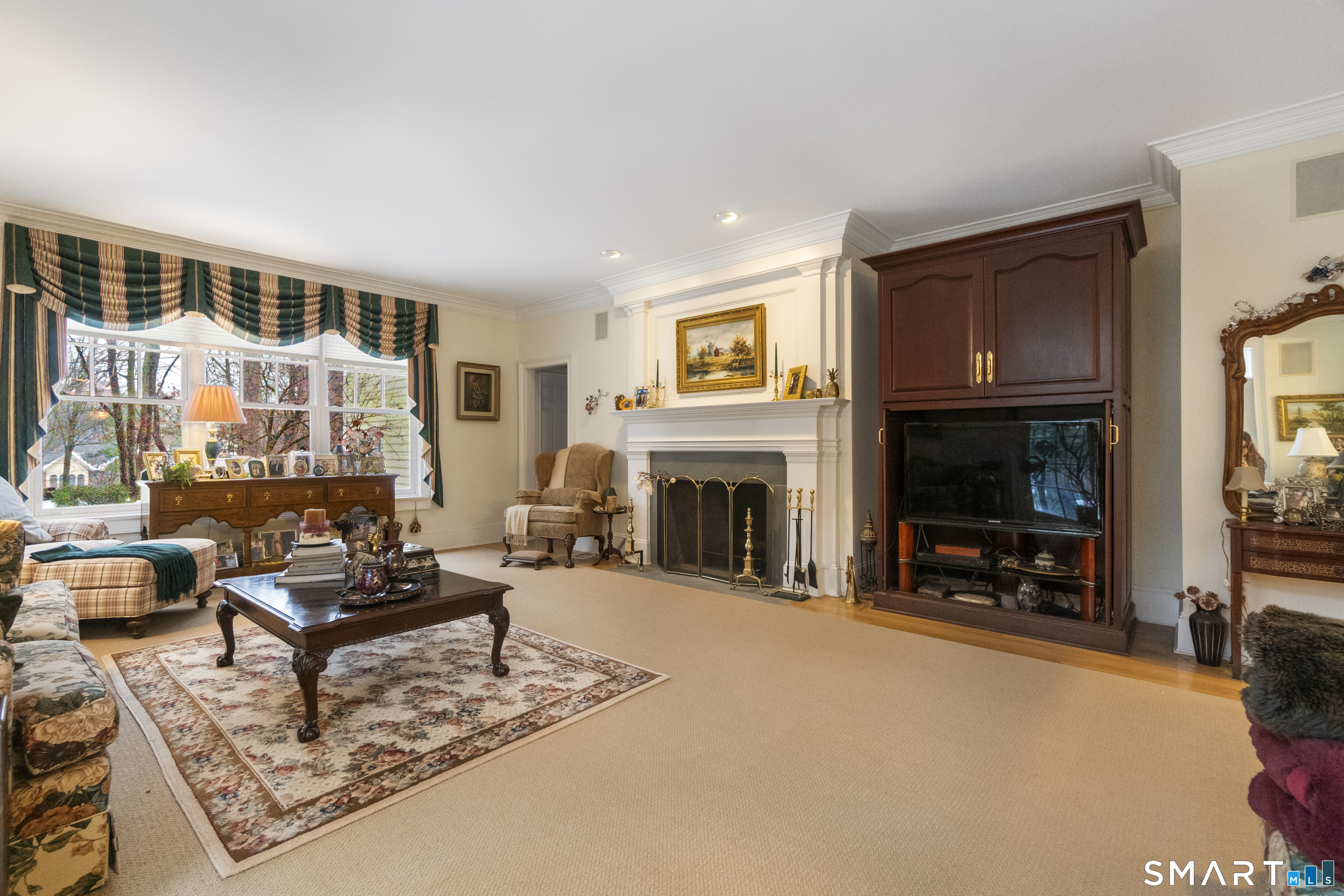 9 Perkins Road Woodbridge, CT 06525 - Photo 21 of 39 a living room with furniture a fireplace and a flat screen tv