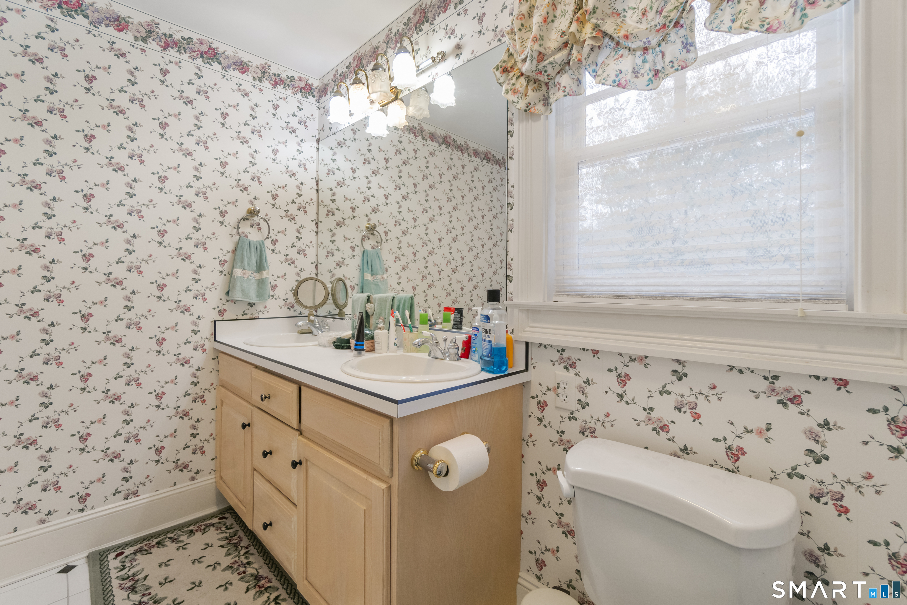 9 Perkins Road Woodbridge, CT 06525 - Photo 26 of 39 a bathroom with a sink a toilet and a mirror