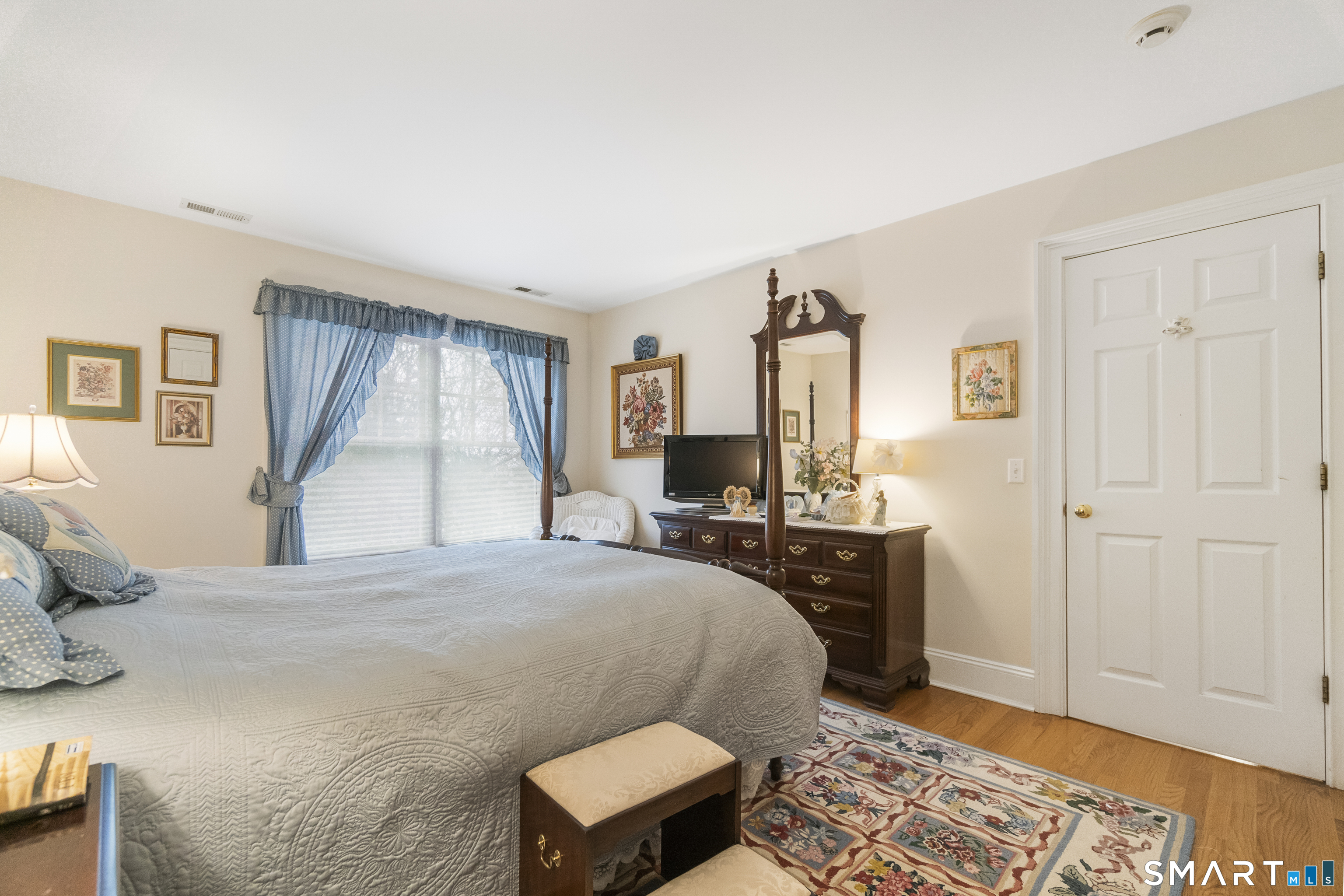 9 Perkins Road Woodbridge, CT 06525 - Photo 31 of 39 a bedroom with a bed and wooden floor