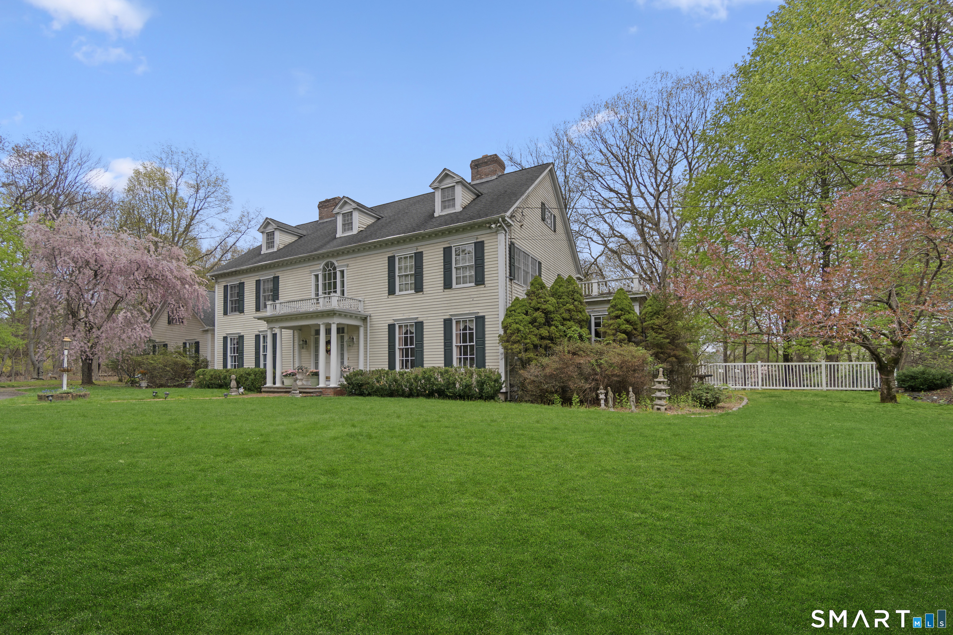 9 Perkins Road Woodbridge, CT 06525 - Photo 5 of 39 a view of a house with a big yard and large trees