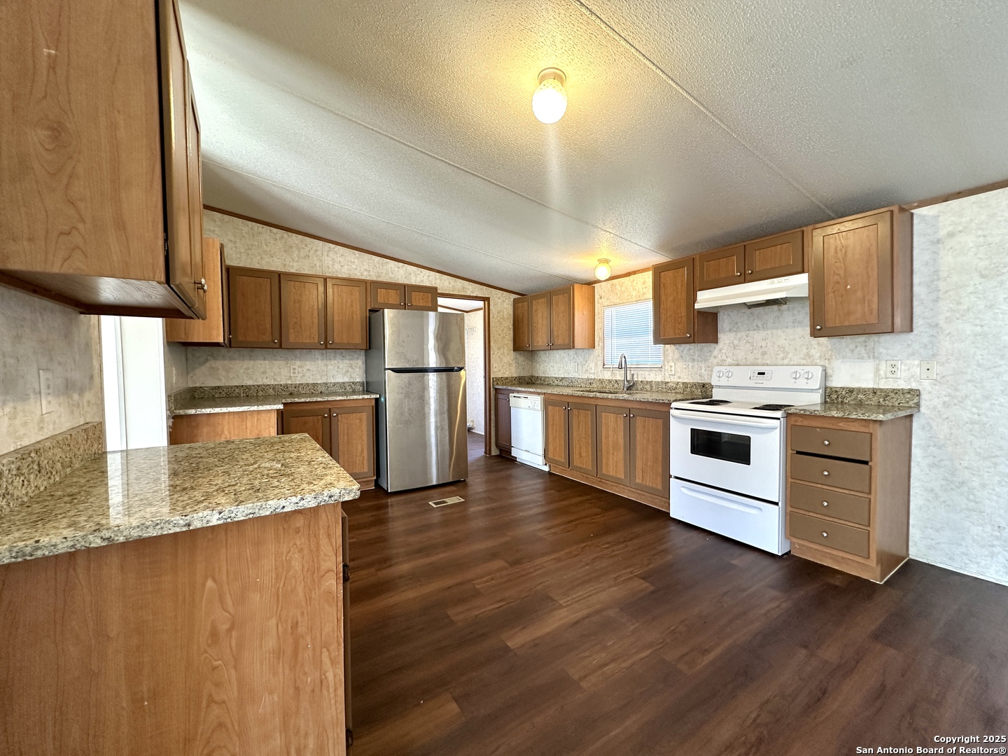 11555 Culebra Road San Antonio, TX 78253 - Photo 3 of 14 a kitchen with stainless steel appliances granite countertop a sink stove and refrigerator