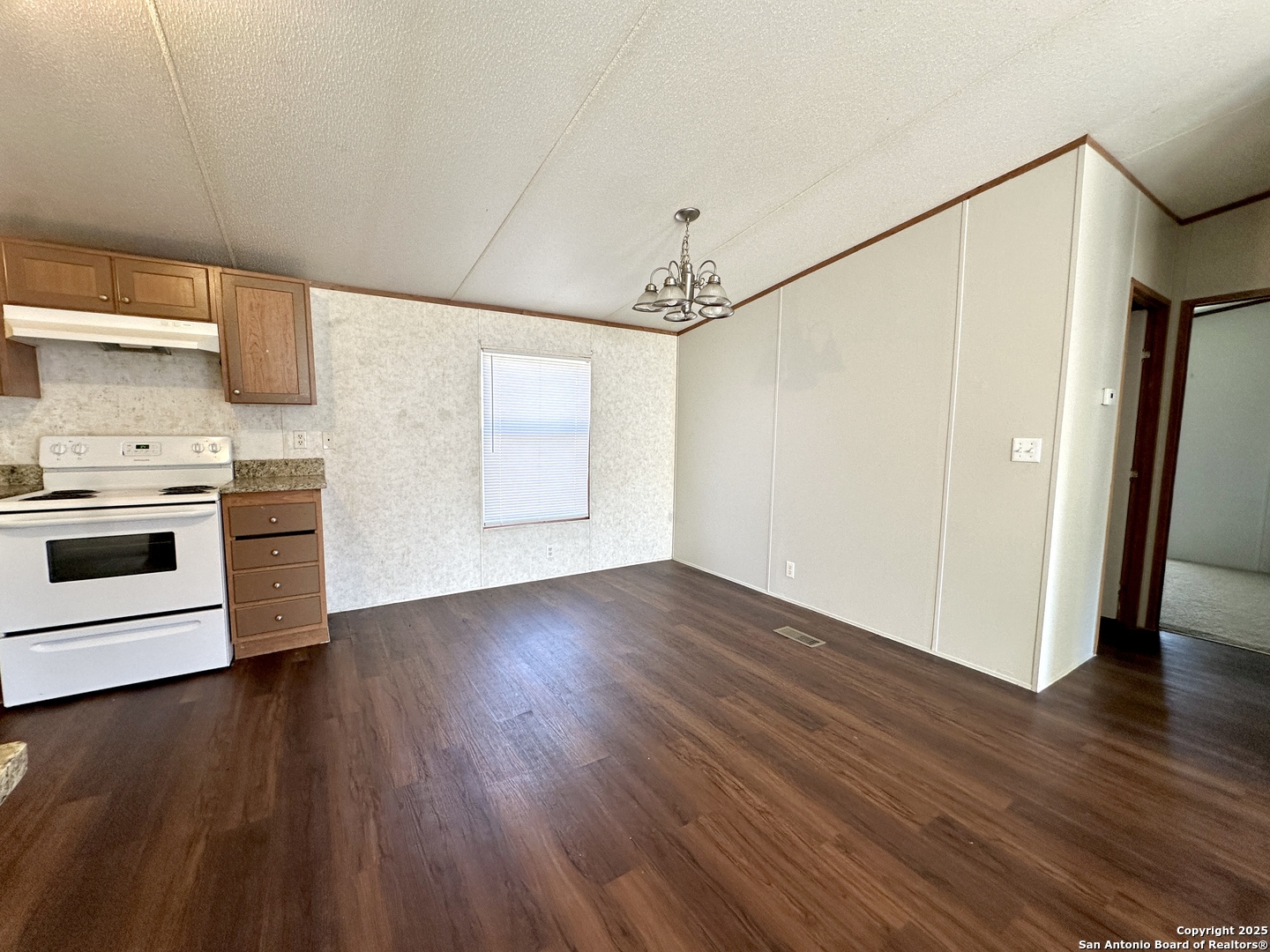 11555 Culebra Road San Antonio, TX 78253 - Photo 4 of 14 a view of a kitchen with a stove wooden floor and a kitchen