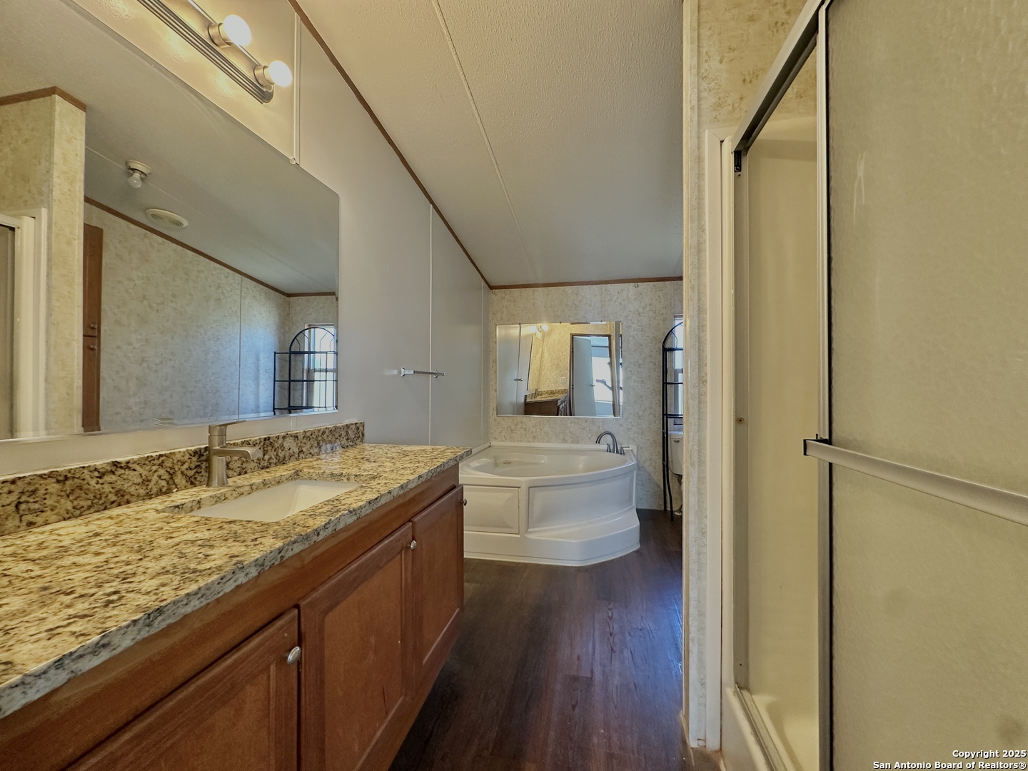 11555 Culebra Road San Antonio, TX 78253 - Photo 6 of 14 a bathroom with a granite countertop sink toilet and shower