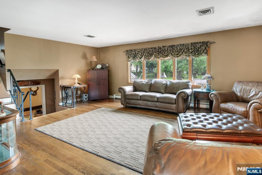 185 Ratzer Road Wayne, NJ 07470 - Photo 10 of 36 a living room with furniture and a flat screen tv