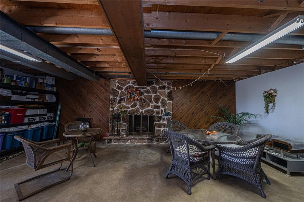 1824 Hassam Road Coraopolis, PA 15108 - Photo 19 of 24 PARTIALLY FINISHED LOWER LEVEL #2 SPACIOUS GAME ROOM 25X17 FEATURES WOOD BURNING FIREPLACE AND SLIDING DOORS TO REAR YARD.