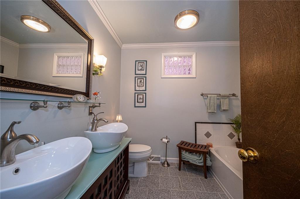1824 Hassam Road Coraopolis, PA 15108 - Photo 8 of 24 MAIN BATH WITH MARBLE FLOORING, SEPARATE TUB AND GLASS STEP IN SHOWER.